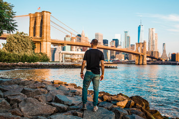 Tourist enjoying amazing view of New York City and Brooklyn bridge