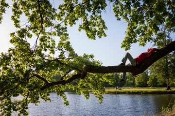 girl resting on a tree branch