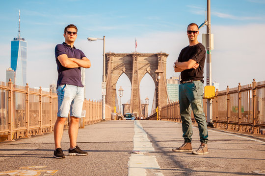 Tourist models posing for a photo on a Brooklyn Bridge