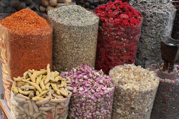 Dried spices in transparent packages standing on the counter in the street market in Dubai