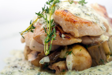 fried pork with mushrooms, potatoes, rosemary and tartar sauce on a white background closeup