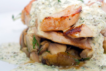 fried pork with mushrooms, potatoes, rosemary and tartar sauce on a white background closeup