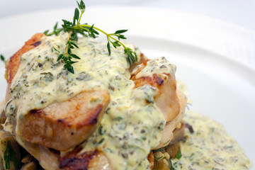 fried pork with mushrooms, potatoes, rosemary and tartar sauce on a white background isolated