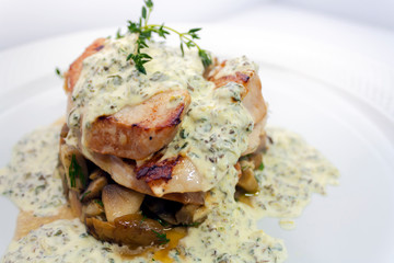 fried pork with mushrooms, potatoes, rosemary and tartar sauce on a white background isolated