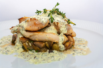 fried pork with mushrooms, potatoes, rosemary and tartar sauce on a white background isolated
