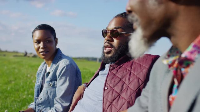 Group of diverse black people in conversation in the countryside