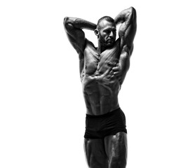 Fototapeta na wymiar Handsome Male Fitness Model Posing, Flexing Muscles