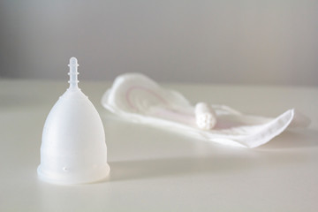 Reusable menstrual cup, disposable pad and disposable tampon