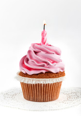 Tasty pink cupcake with candle for Happy Birthday on light background. Holiday cake celebration, close up.