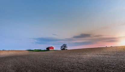 Red barn in the countryside on a Maryland farm at sunset