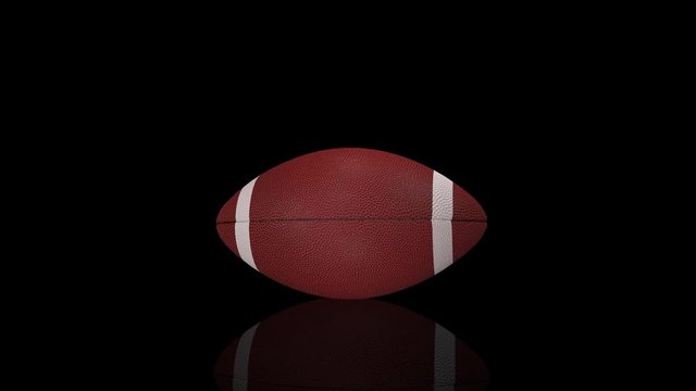 3D animation, american football ball rolling in place, horizontal position.