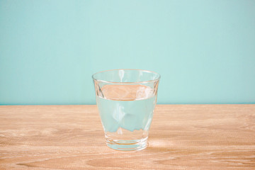 Glass of water on the table.  テーブルの上のグラス一杯の水