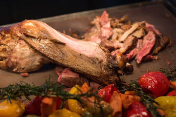 grilled goat with vegetables and spices on a cutting Board