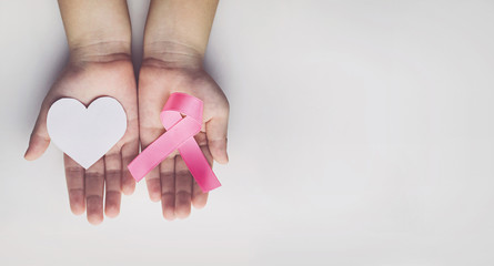 Child holding pink ribbon. breast cancer awareness
