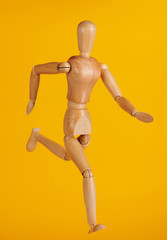 Running wooden doll