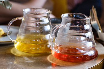 Two teapots with different colors fruit tastes of tea