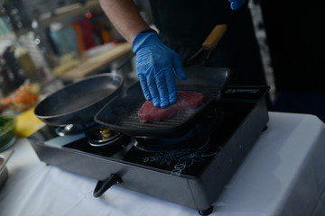 Making food in restaurant. Proffesional cooker.