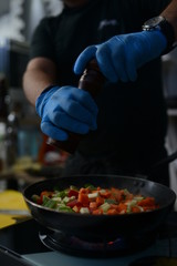 Making dinner at restaurant. Proffesional cooker