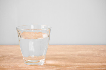 Glass of water on the table. テーブルの上のグラス一杯の水