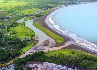 River Delta Meet The Blue Calm Ocean. Muddy River Flow its Sediment Into Seashore or Beach. Aerial...