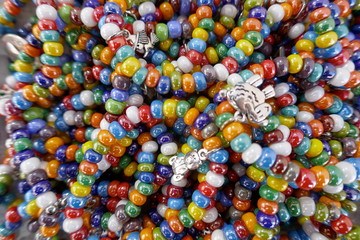 Fototapeta na wymiar Many, colorful necklaces and bracelets made of glass beads