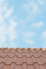 Roof house with tiled roof on blue sky