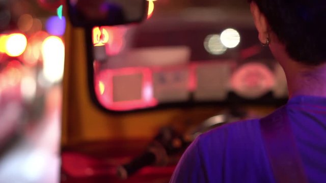 4k footage of Tuk Tuk Driver In Bangkok, Thailand Driving Through A Busy Street