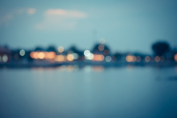 Beautiful blurred city lights with bokeh effect reflected on water