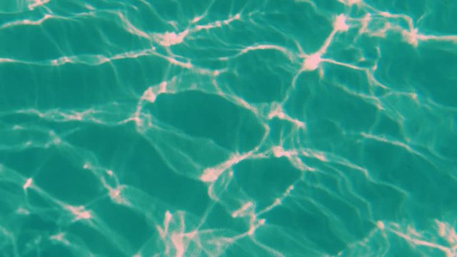 Green and pink texture with fluctuating waves of light. Light waves and clusters in motion.  Blurry crumpled surface distortion in  complementary colors.
