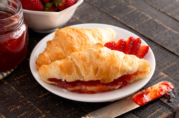 Croissants Filled with Fresh Homemade Strawberry Jam on Wooden Table