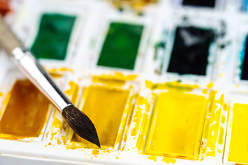 Set watercolor paints with paintbrush. Art concept