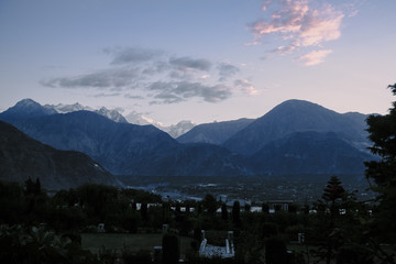 Serene landscape view of sunrise over Karakoram mountain range in Jutial, Gilgit city. Gilgit Baltistan, Pakistan. Dark scene at dawn. 