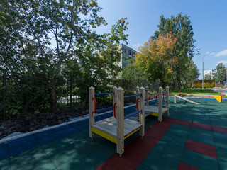 children's playground with green and red softfall rubber surface