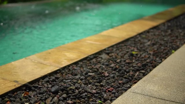 close up amaizing video of summer tropical rain, raindrops fall onto stone floor