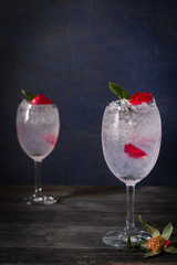 Sparkling cold water detox with rose and ice on the wood table there is same object place back side