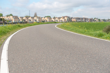 Empty curved road on a dam in the dutch countryside, Capelle Aan Den Ijssel, Netherlands
