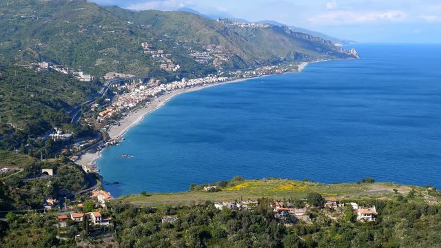 High angle view of motorway above Letojanni town on the blue Ionian sea coast of Sicily island