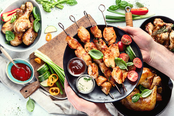 Man holding  kebabs on skewers