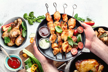 Man holding  kebabs on skewers