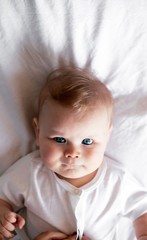 Sweetheart newborn girl lying on bed stunning artistic portrait indoors