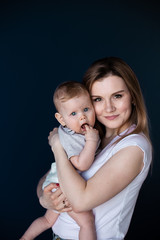 Proud mother and baby newborn girl stunning artistic portrait