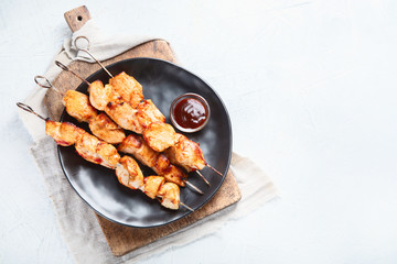 Grilled chicken on skewers. Top view, flat lay with copy space