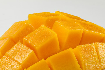 ripe yellow mango cut slice whole on white background