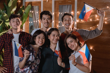 friend celebrating philippines national independence day party at night in the home backyard together