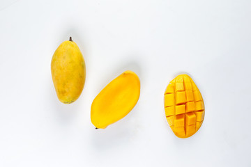 ripe yellow mango cut slice whole on white background