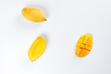 ripe yellow mango cut slice whole on white background