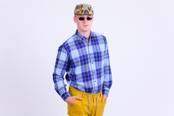 Portrait of young handsome hipster man with sunglasses as artist