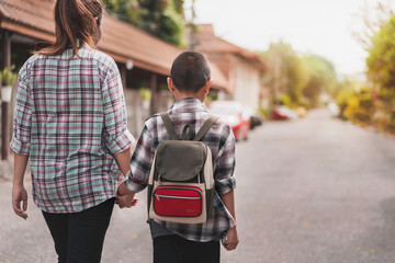 Mother or parent holding hand son or pupil with backpack go to school, Back to school concept, Selective focus.