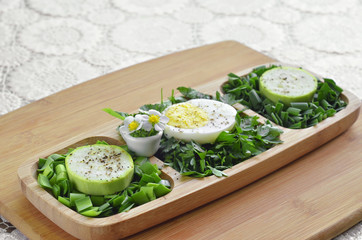 Finally chopped different greens with egg and raw zucchini in a wooden plate. Selective focus