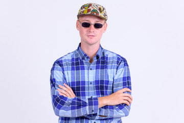 Portrait of young handsome hipster man with arms crossed
